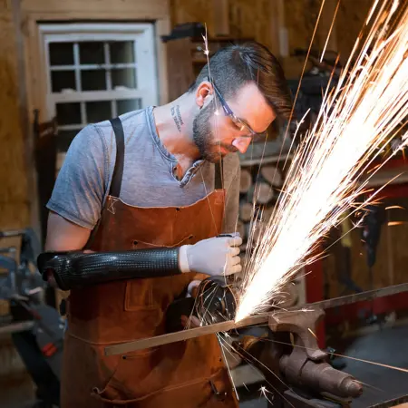 Man with arm prosthesis in workshop